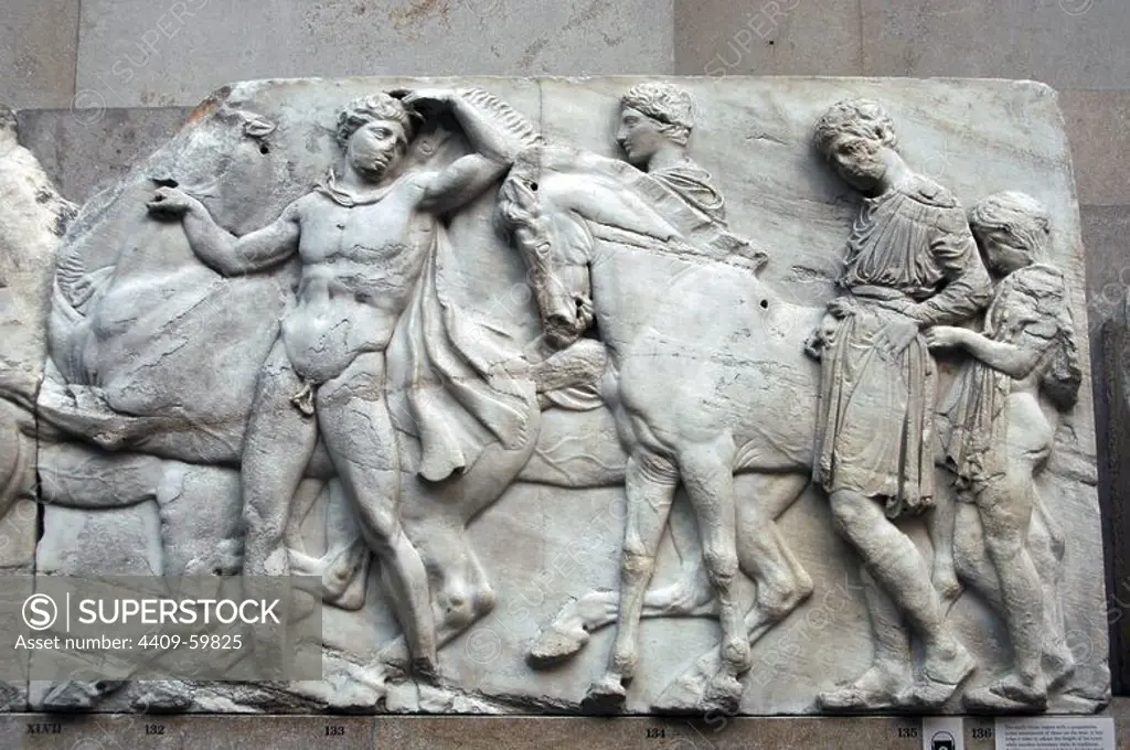 Greek Art. Parthenon. 5th century B.C. A boy helps a rider to adjust the length of his tunic while another horseman waits in readiness. North frieze XLVII. It comes from the Acropolis in Athens. British Museum. London. England. UK.