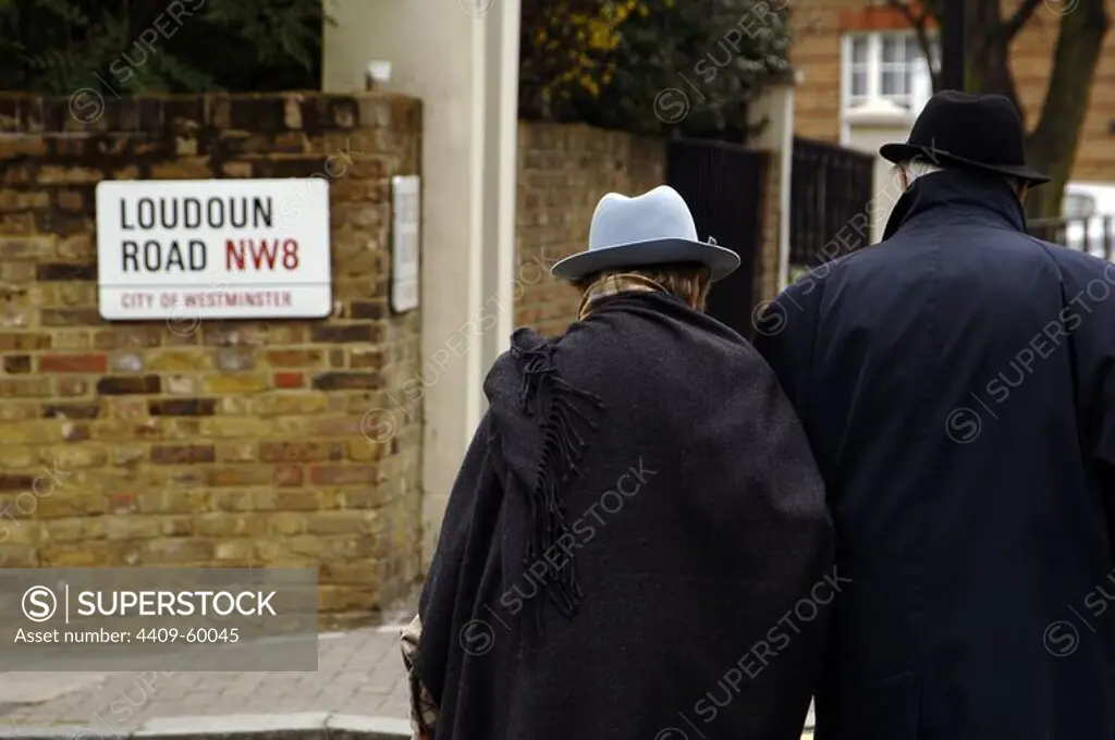 Elderly couple wearing hat strolling in Hampstead. London, England, United Kingdom.
