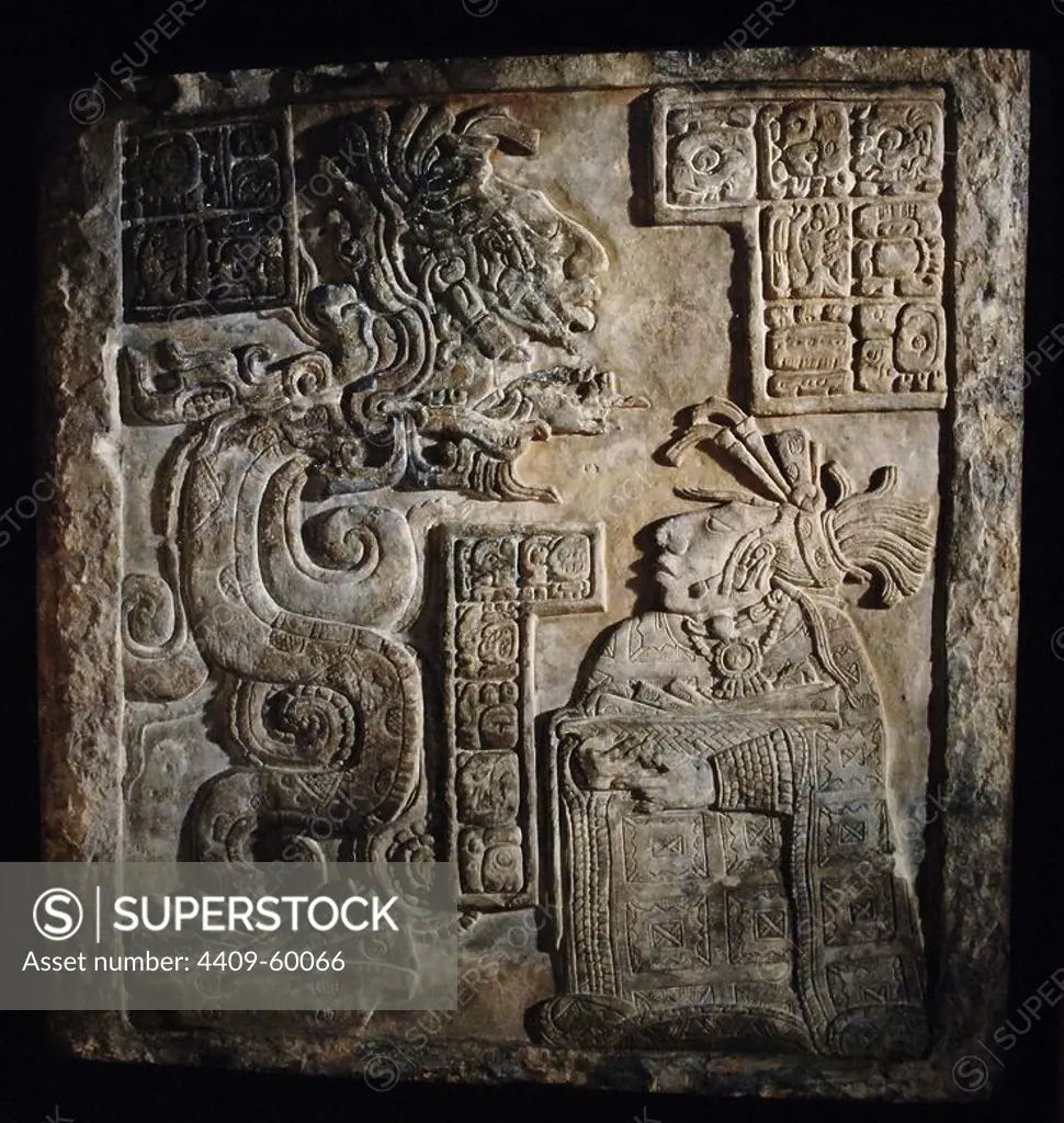 The Yaxchilan Lintels. Lintel 15. Structure 21. Carved limestone lintel with glyphs and a scene representing Lady Wak Tuun, during a bloodletting rite. She is carrying a basket with the paraphernalia used for auto-sacrifice: stingray spine, a rope and bloodied paper. The vision serpent appears before her springing from a bowl set before her which also contains strips of bark-paper. Late Classic Maya, 770. Limestone. Yaxchilan, Chiapas, Mexico. British Museum. London, England, United Kingdom.