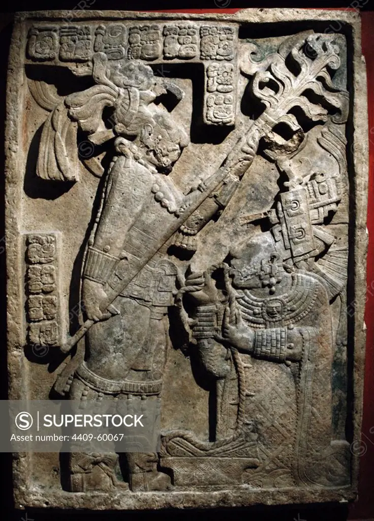 The Yaxchilan Lintels. Lintel 24. Structure 23. Carved limestone lintel. Depiction of a bloodletting ritual performed by the king of Yaxchilan, Shield Jaguar II and his wife, Lady K'ab'al Xook. The king holds a flaming torch over his wife, who is pulling a thorny rope through her tongue. Scrolls of blood can be seen around her mouth. Classic Maya. 723-726. Limestone. Yaxchilan, Chiapas, Mexico. British Museum. London, England, United Kingdom.
