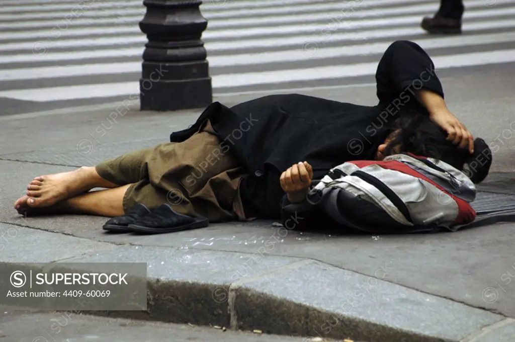 Indigent sleeping in the street.