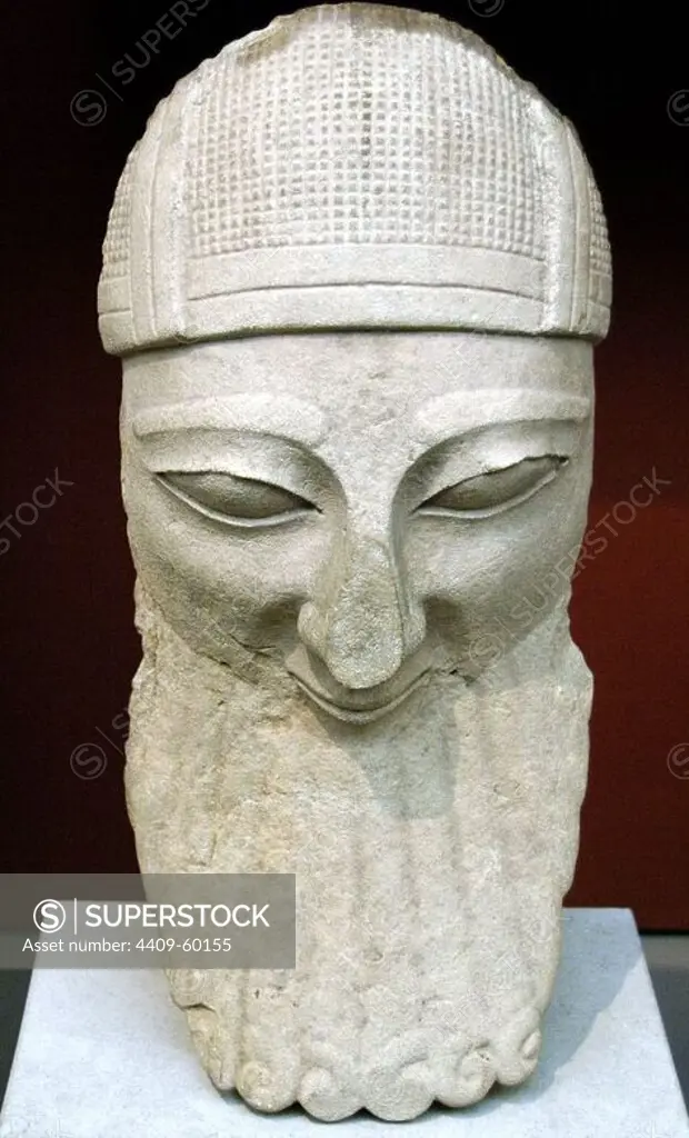 Head from a colossal statue of a bearded worshipper with helmet. Limestone. Made in Cyprus. 570-550 BC. From Byblos. British Museum. London. England. United Kingdom.
