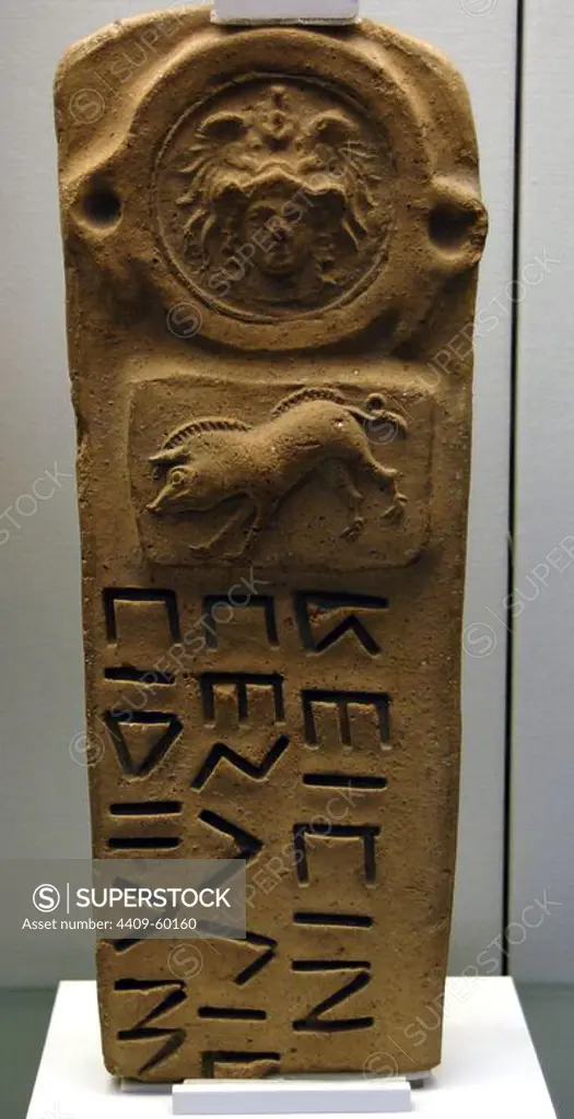 Boundary-marker with Oscan inscription. Used to mark the confines of sacred area. Decorated with reliefs depicting helmeted goddess Athena and a boar. Terracotta. 300-100 BC. From a tomb near Capua. British Museum. London. England. United Kingdom.