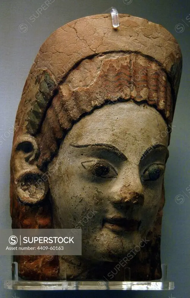 Etruscan painted antefix with shaped head of woman with earrings. 520-500 BC. From Cerveteri. British Museum. London. England. United Kingdom.