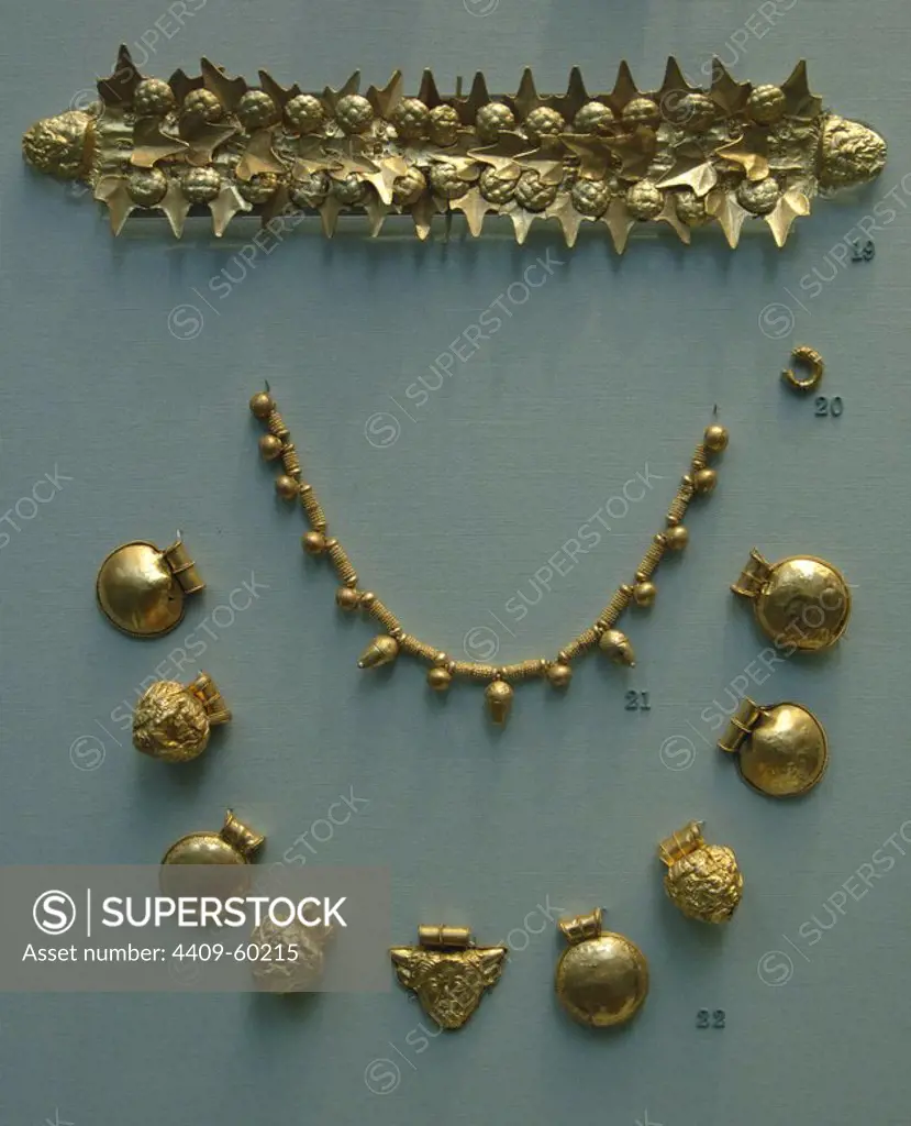 Gold etruscan jewelry: Funerary wreath with ivy leaves and berries and a satyr's head at the ends, earring in the form of a hollow trumpet-shaped loop, necklace and nine pendants (bullae) from a necklace. 400-350 BC. From a tomb near Tarquinia. British Museum. London. England. United Kingdom.