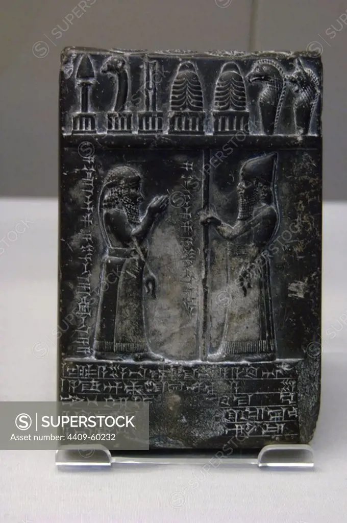 Mesopotamian Art. Middle Babylonian. 875-850 B.C. Black diorite tablet carved with labelled scene showing Nabu-apla-iddina, the priest, standing with his right hand raised in the presence of the king.(Obverse). Inscribed with cuneiform script. British Museum. London. United Kingdom.