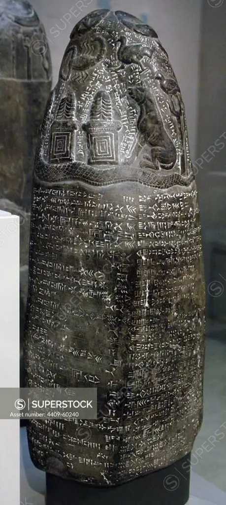 Mesopotamian Art. Middle Babylonian. Limestone kudurru from the riegn of Marduk-nadin-ahhe (1099Ð1082 BC). Block of black limestone. The upper portion is carved with symbols. Inscribed with cuneiform script. Land grant. British Museum. London. United Kingdom.