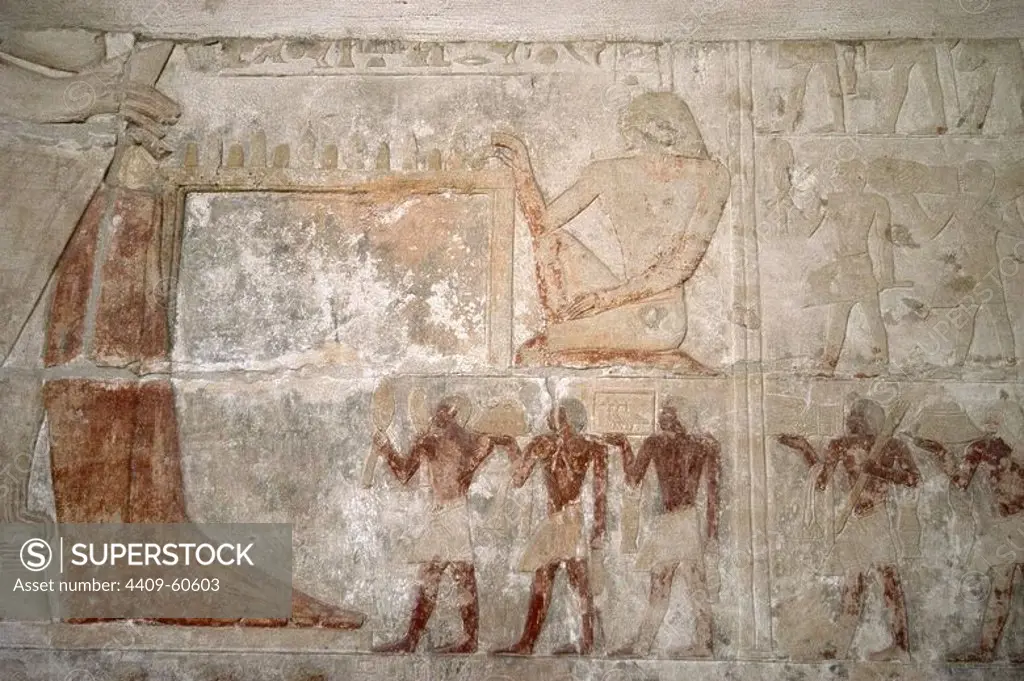 Egypt. Necropolis of Saqqara. Mastaba of Mereruka, priest of Pharaoh Teti. 2.340 B.C. Polychrome relief depicting offering bearers to Mereruka who is shown with his wife, Watetkhethor, seated and playing a game of senet. 6th Dynasty. Old Kingdom.