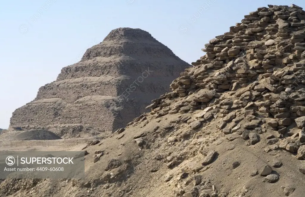 Pyramid of Userkaf. Built Ca. 2490 B.C. At background, the step Pyramid of Djoser. Old kingdom. Saqqara. Egypt.