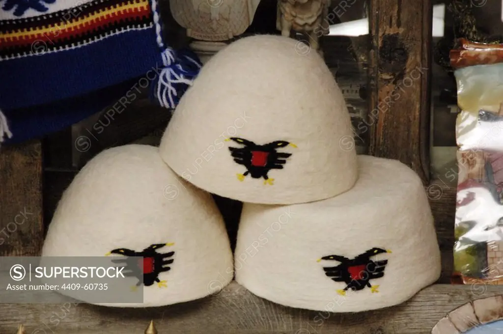Albania. Kruje. Selling hats with the coat of Albania. Bazaar.