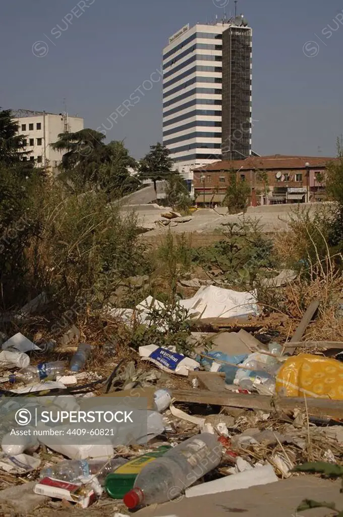 Republic of Albania. Tirana. Rubbish on the street. In the background, the International Hotel.