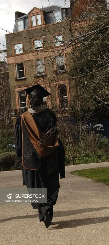 Lawyer walking down Russell Square wearing the toga and the square academic cap. London. United Kingdom.