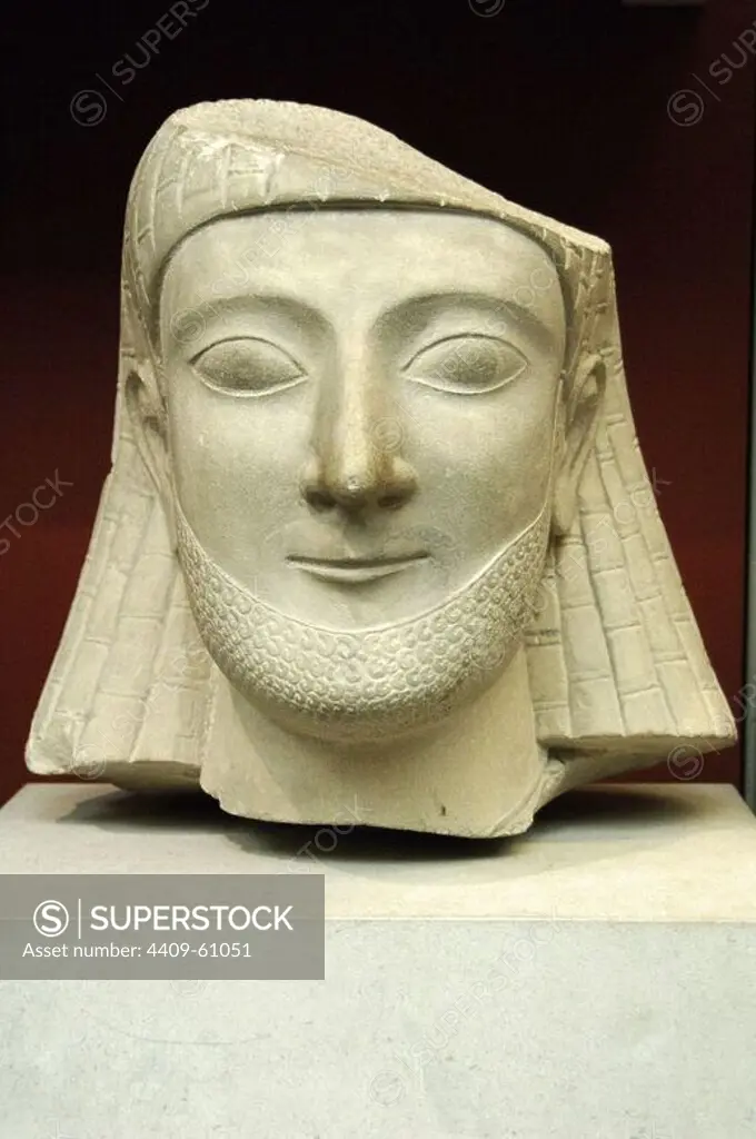 Limestone head of a bearded worshiper with hair arranged in the Egyptian style wig with braided. Carved in Cyprus. 550 BC. From the Sanctuary of Apollo at Idalion. British Museum. London. United Kingdom.