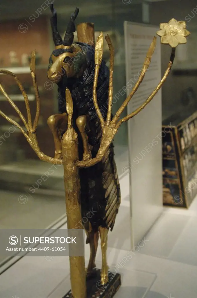 The Ram in a Thicket. Rampant Ram perched on the tree of life, covered with gold leaf. The horns, eyes and back of the animal are of lapis lazuli. The base on silver. Possibly served as a offerings pedestal or a harp motif. Found at a pit PG 1237 of the Royal Cemetery of Ur. 2600-2400 BC. British Museum. London. United Kingdom.