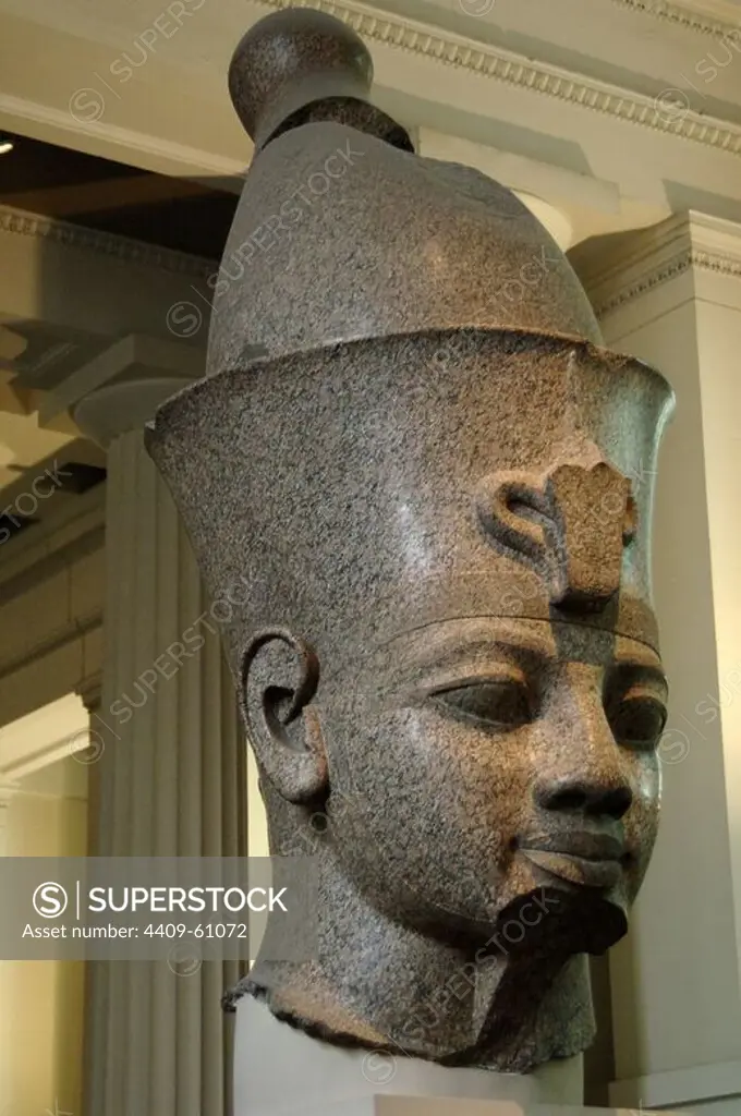 Head from monumental red granite statue of an egyptian king wearing the double crown. Probably Amenhotep III. Around 1390 BC. 18th Dynasty. New Kingdom. From the temple of Mut, Karnak,Thebes. British Museum. London. United Kingdom.