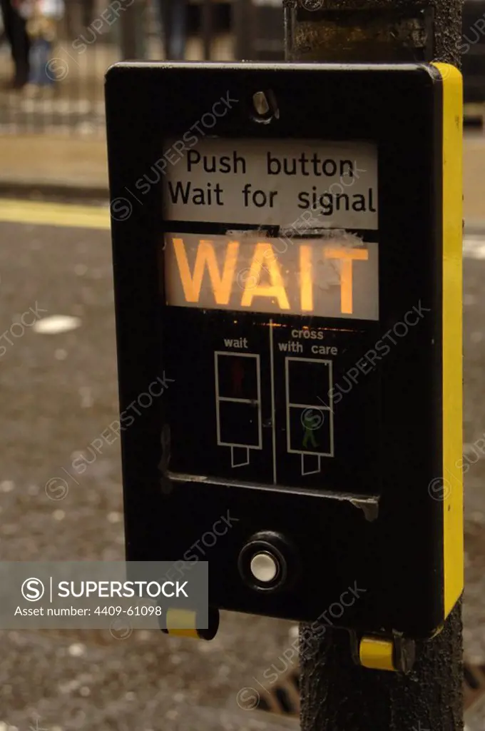 United Kingdom. London. Pedestrian traffic light switch indicating that they must wait to cross. The order change by pressing the button.