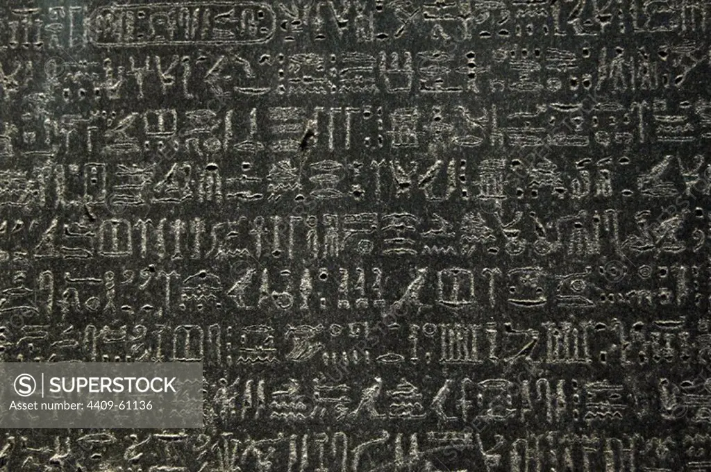 The Rosetta Stone. Fragment of a black granite stele with an inscription in different languages __of a decree of Ptolemy V Epiphanes king. Ptolemaic era. 196 BC. Detail. Hieroglyphical scripture. British Museum. London. United Kingdom.