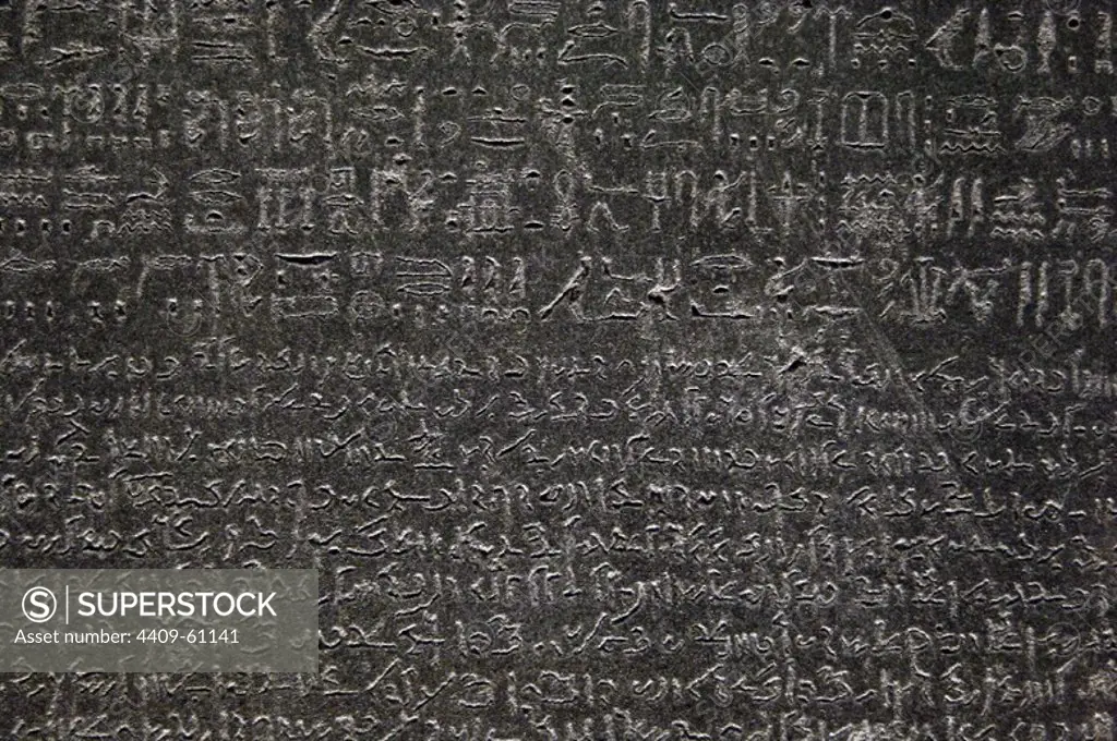 The Rosetta Stone. Fragment of a black granite stele with an inscription in different languages __of a decree of Ptolemy V Epiphanes king. Ptolemaic era. 196 BC. Hieroglyphical and demotic scripture. Detail. British Museum. London. United Kingdom.