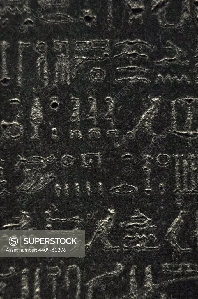 The Rosetta Stone. Fragment of a black granite stele with an inscription in different languages __of a decree of Ptolemy V Epiphanes king. Hieroglyphic scripture. Detail. Ptolemaic era. 196 BC. British Museum. London. United Kingdom.