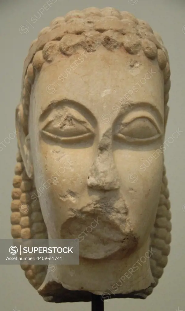 Head of a kouros found in Athens, in the Kerameikos, near Dipylon Gate, c. 600-590 BC. Archaic style. National Archaeological Museum of Athens. Greece.