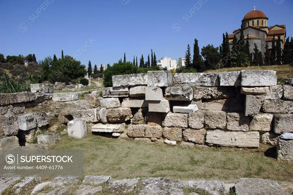 Greece, Athens. Area of Kerameikos (Ceramicus). Its name derives from "potter's quarter". Northwest of the Acropolis. Old cemetery. Ruins. Agia Triada Church at back.