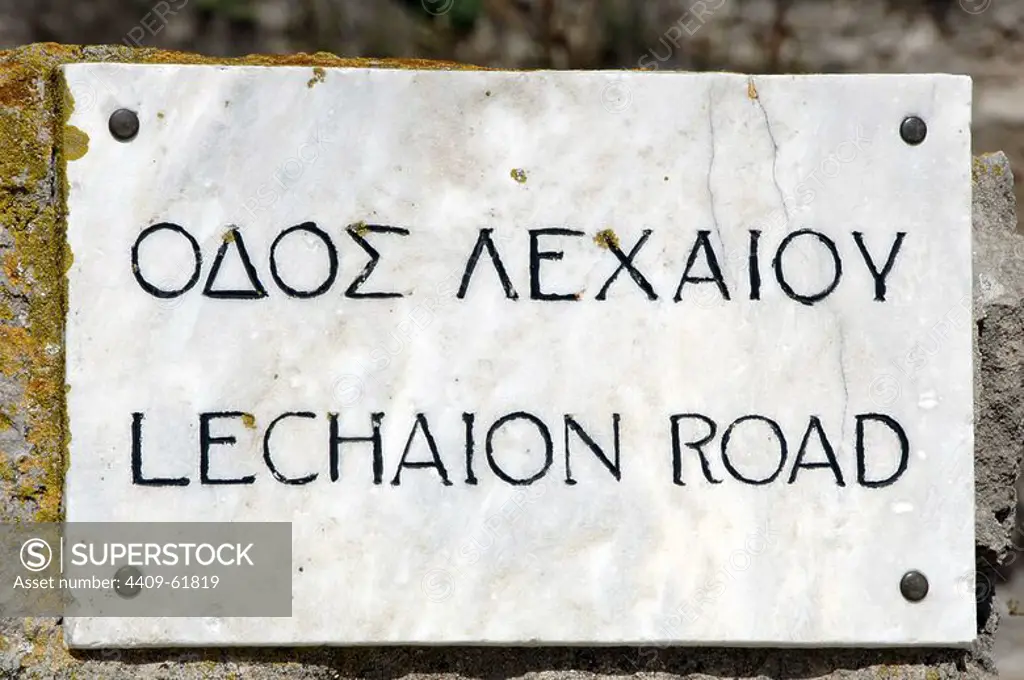 Greece. Ancient Corinth. Bilingual inscription in Greek and English, regarding the Lechaion road. Marble-paved road to the port of Lechaion. Peloponnese.