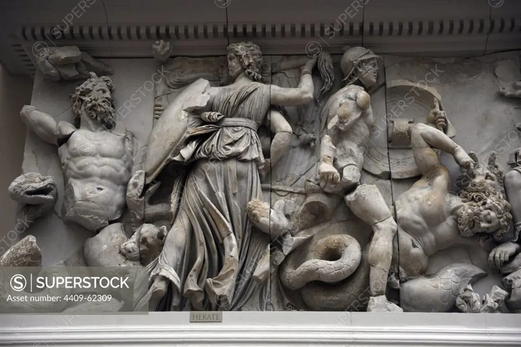 Pergamon Altar. Built by order of Eumenes II Soter. 164-156 BC. Marble and limestone. Gigantomachy. South frieze. The three-faceted goddess Hecate fighting with a torch, a sword and a lance against the giant Klytios. Next to her is Artemis (she doesn't appear) fighting with a bow and arrow against a Giant who is perhaps Otos (he doesn't appear). Her hunting dog kills another Giant with a bite to the neck. Pergamon Museum. Berlin. Germany.
