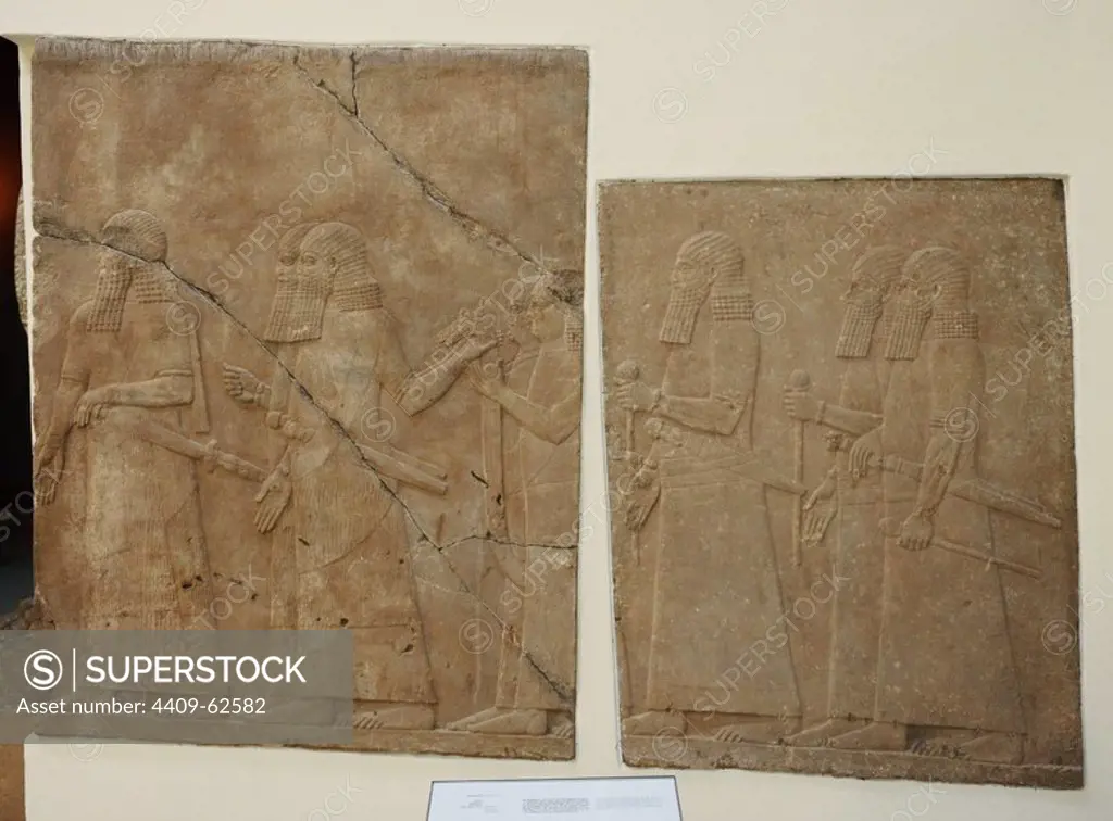 Mesopotamian art. Assyrian. Orthostates with reliefs in the side walls of a ramp from the Palace of Nineveh. Alabaster. 704-689 B.C. It shows Assyrian officers and courtiers carrying a mobile throne. Pergamon Museum. Berlin. Germany.