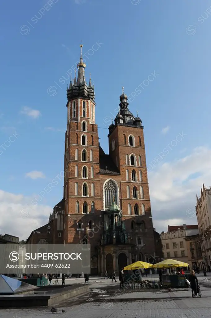 POLAND. KRAKOW. View of the Central Market Square with Saint Mary's Basilica founded in 1222 by the Bishop of Krakow Iwo Odrowaz and destroyed by the Tartars in 1241.The actual building was built between 1345 and 1408 with two towers of the fourteenth century with later additions in different styles.