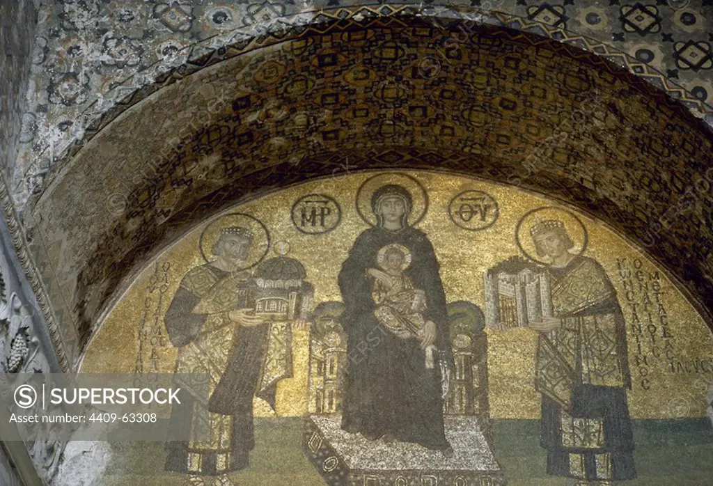 Istanbul, Turkey. The Hagia Sophia. Mosaic depicting the Virgin Mary, holding Jesus, flanked by Emperors Constantine the Great (on the right) holding a model of the city of Constantinople, and Justinian I (on the left) holding a model of Hagia Sophia. Tympanum above the Southwestern entrance, 944.