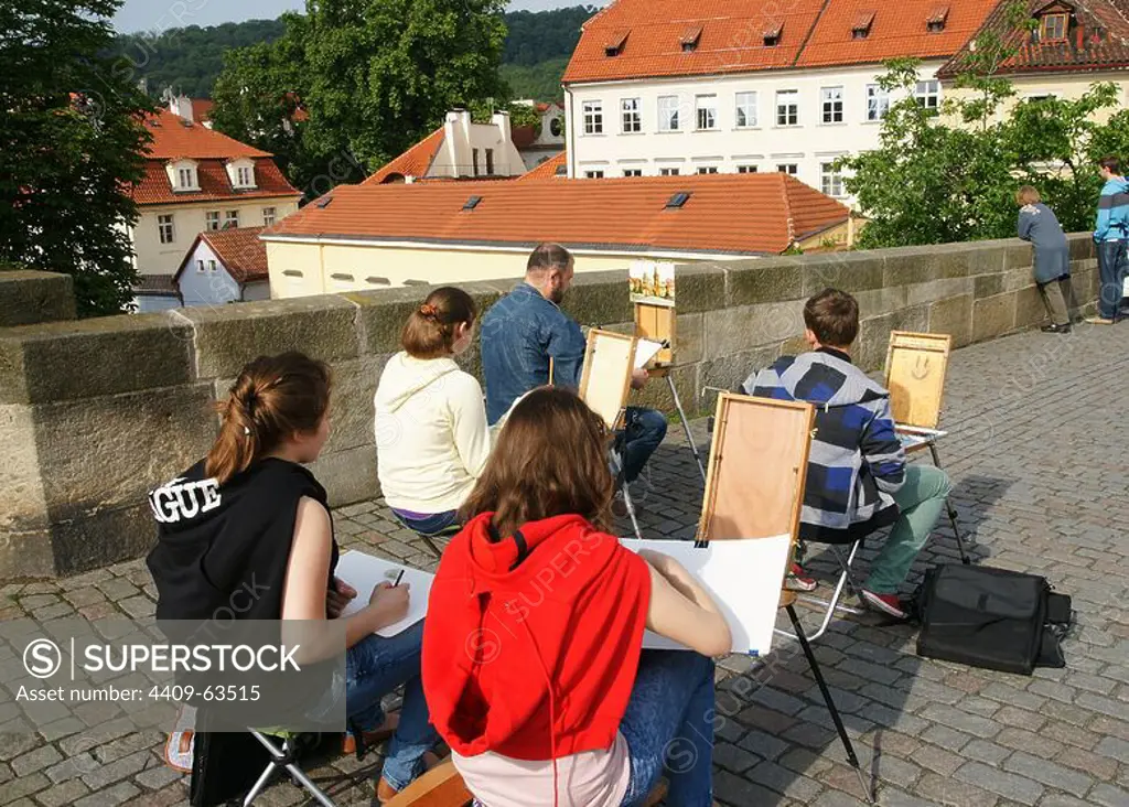 Czech Republic. Prague. Painting classes. Young drawing on Charles Bridge.