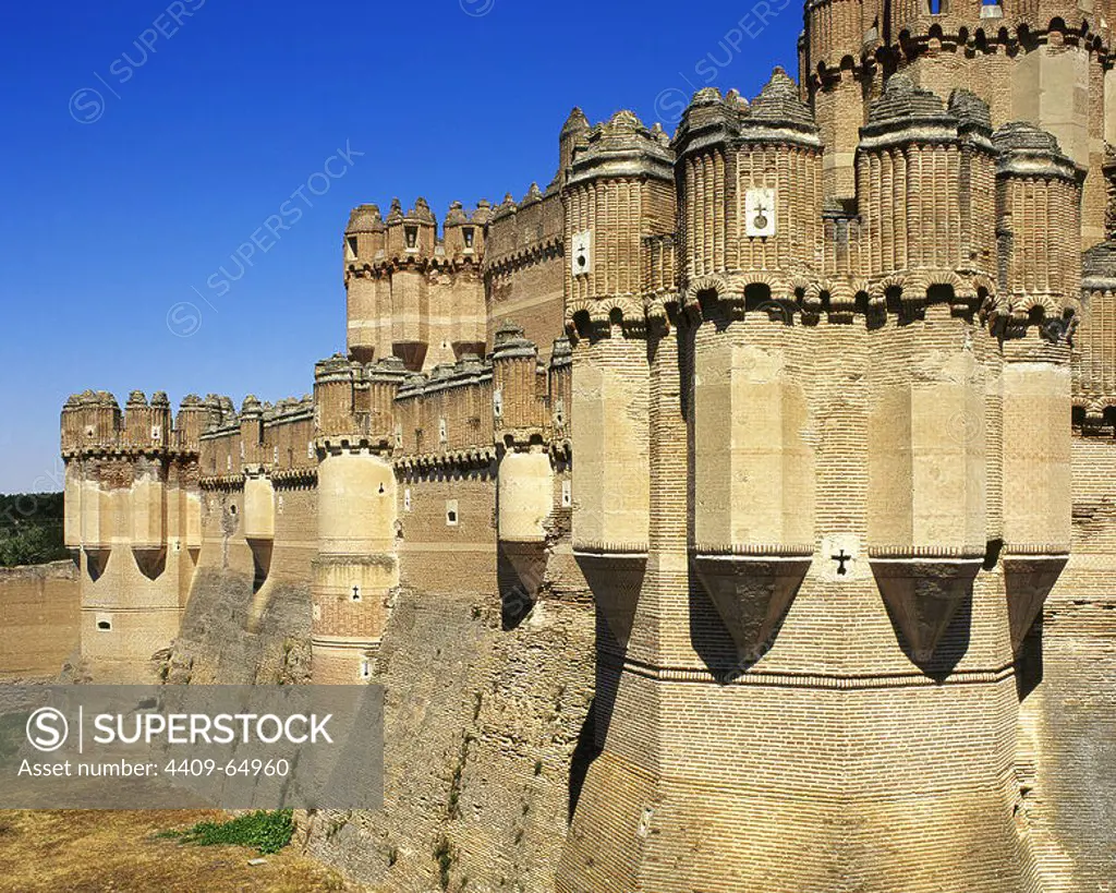 Spain, Castile and Leon, province of Segovia. Coca Castle. It was built in the late 15th century by the Castilian magnate Don Alonso de Fonseca. Mudejar style. Battlements of a tower. Exterior architectural detail.