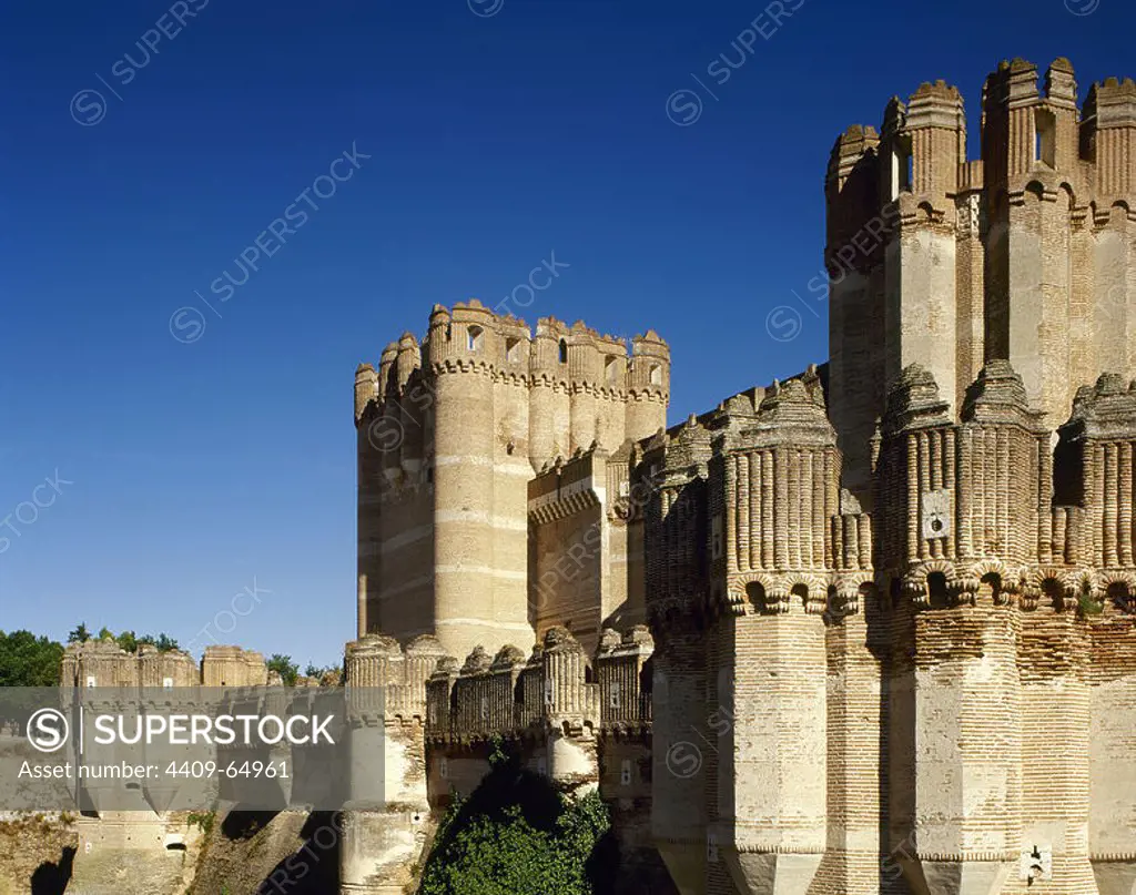 Spain, Castile and Leon, province of Segovia. Coca Castle. It was built in the late 15th century by the Castilian magnate Don Alonso de Fonseca. Mudejar style. Battlements of a tower. Exterior architectural detail.