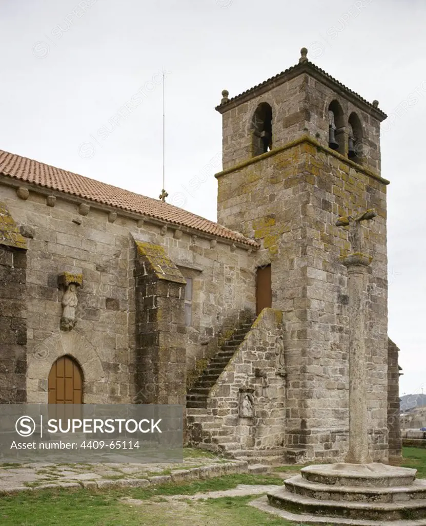 Ponteceso, La Corua province, Galicia, Spain. The church of Santa Maria da Atalaia. It was built at the end of 14th century in Gothic sailor style, by Dame Urraca de Moscoro by express wish of his mother Dame Juana de Castro and Lara. Bell tower and calvary stone.