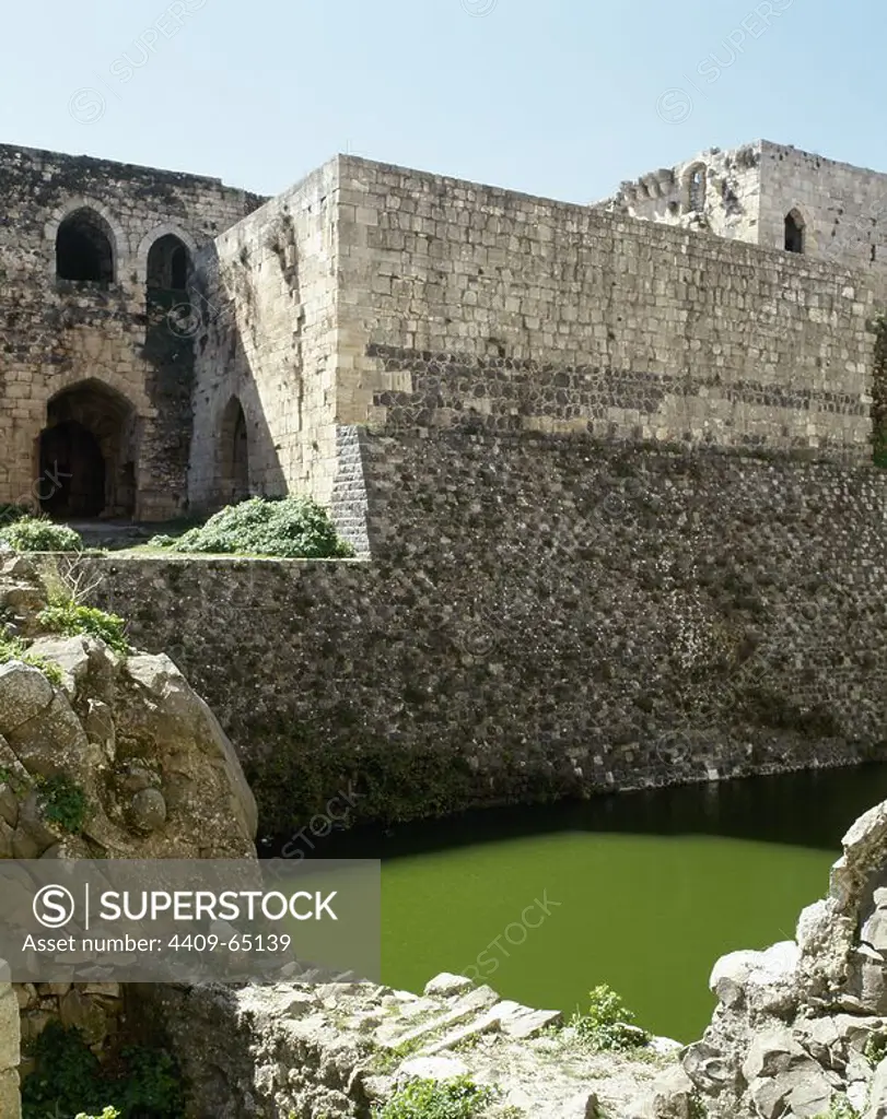 Syria. Talkalakh District, Krak des Chevaliers. Crusader castle, under control of the Knights Hospitaller (1142-1271) during the Crusades to the Holy Land, fell into Arab control in 13th century. View of the moat. Photo taken before the Syrian Civil War.