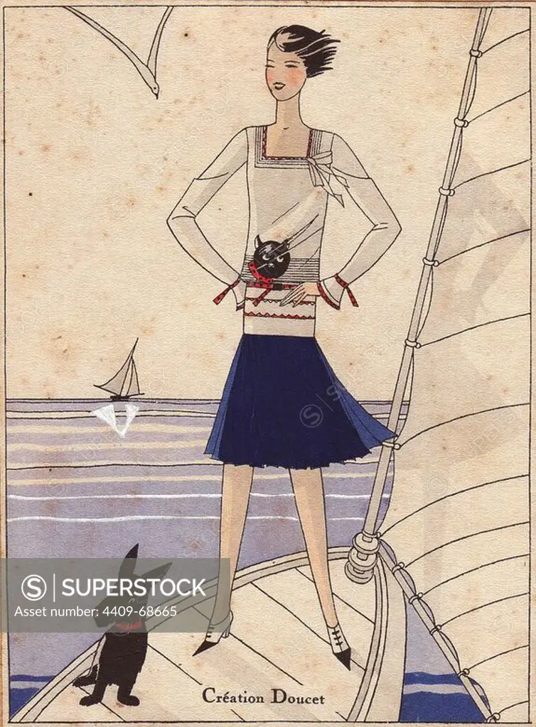 Woman standing on yacht wearing 1930 sailor fashion, a navy blue skirt, white blouse with a design of a cat's head. Black dog in foreground.. Handcolored pochoir (stencil) lithograph from the French luxury fashion magazine "Art, Gout, Beaute" 1930.