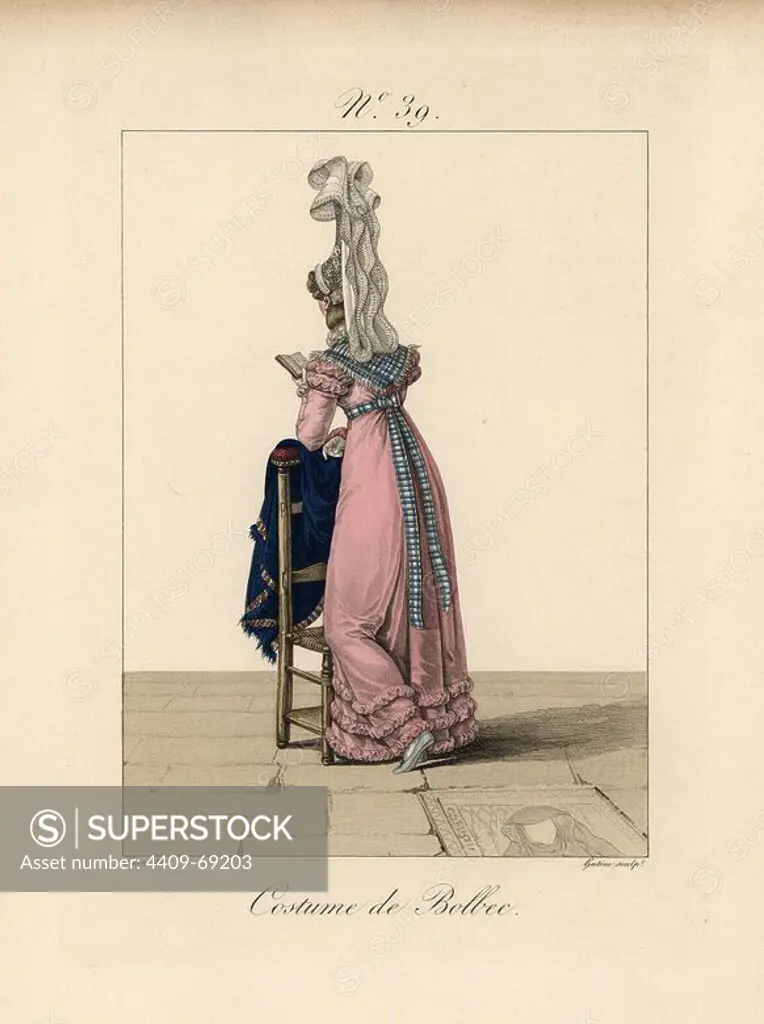 Woman in costume of Bolbec, reading a book while resting against a chair. This bavolet bonnet is the most beautiful we have seen, because the veil falls from such a great height with great playfulness. Hand-colored fashion plate illustration by Lante engraved by Gatine from Louis-Marie Lante's "Costumes des femmes du Pays de Caux," 1827/1885. With their tall Alsation lace hats, the women of Caux and Normandy were famous for the elegance and style.