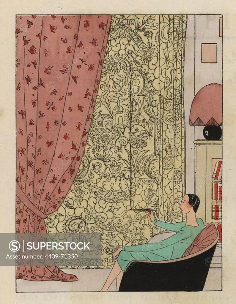 Interior scene from 1930. Woman in green dress smoking a cigarette in a black chair, dusty pink curtains and yellow printed wall hanging. Bookcase, lamp in living room.. Handcolored pochoir (stencil) lithograph from the French luxury fashion magazine "Art, Gout, Beaute" 1930.