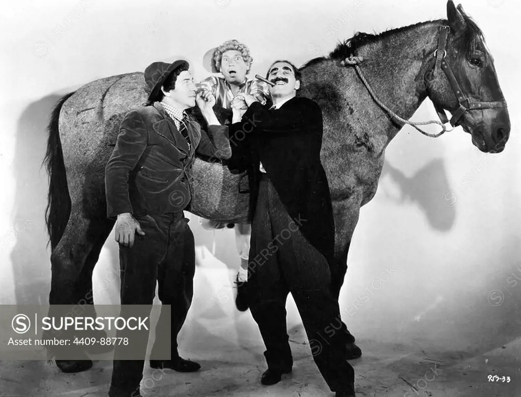 HARPO MARX, THE MARX BROTHERS, CHICO MARX and GROUCHO MARX in A DAY AT THE RACES (1937), directed by SAM WOOD.