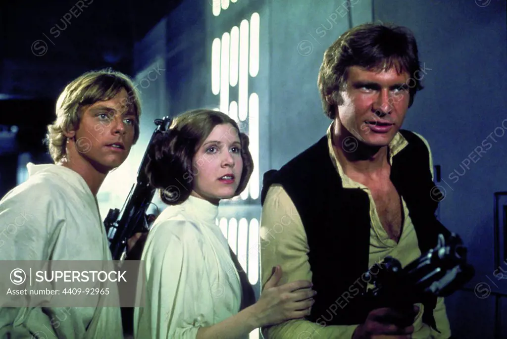 HARRISON FORD, CARRIE FISHER and MARK HAMILL in STAR WARS: EPISODE IV-A NEW HOPE (1977), directed by GEORGE LUCAS.