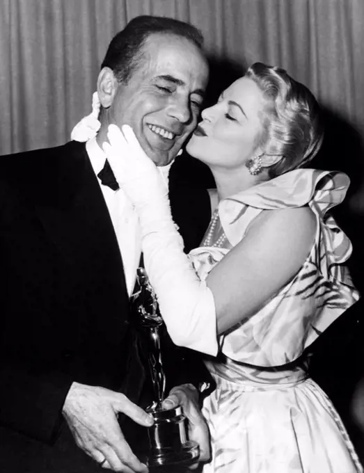 The 24th Academy Awards / 1952. Best Actor winner for 'The African Queen', with presenter Claire Trevor.