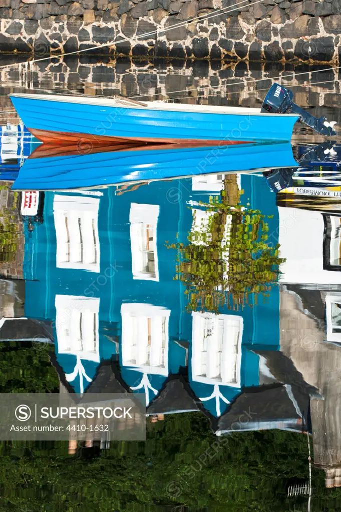 Reflection of house and boat in the harbor in Tobermory, Isle of Mull, Inner Hebrides, Scotland