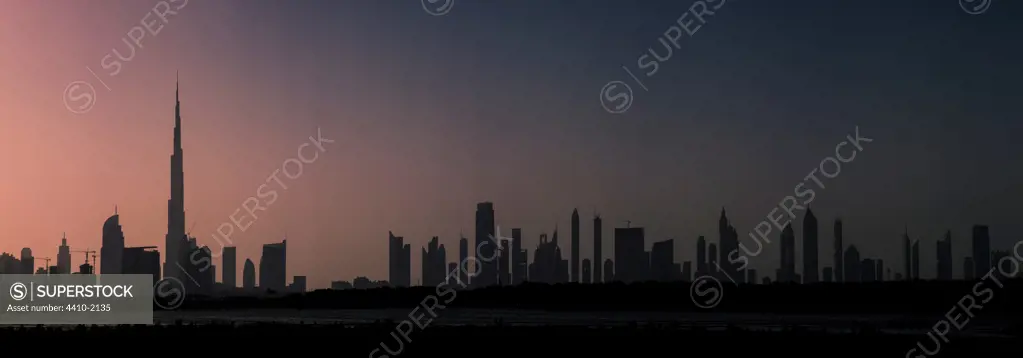 United Arab Emirates, Dubai, Sunset at Ras Al Khor Wildlife Sanctuary (Ramsar site), with Dubai skyline in background including Burj Khalifa (world's tallest building at 829.8m)