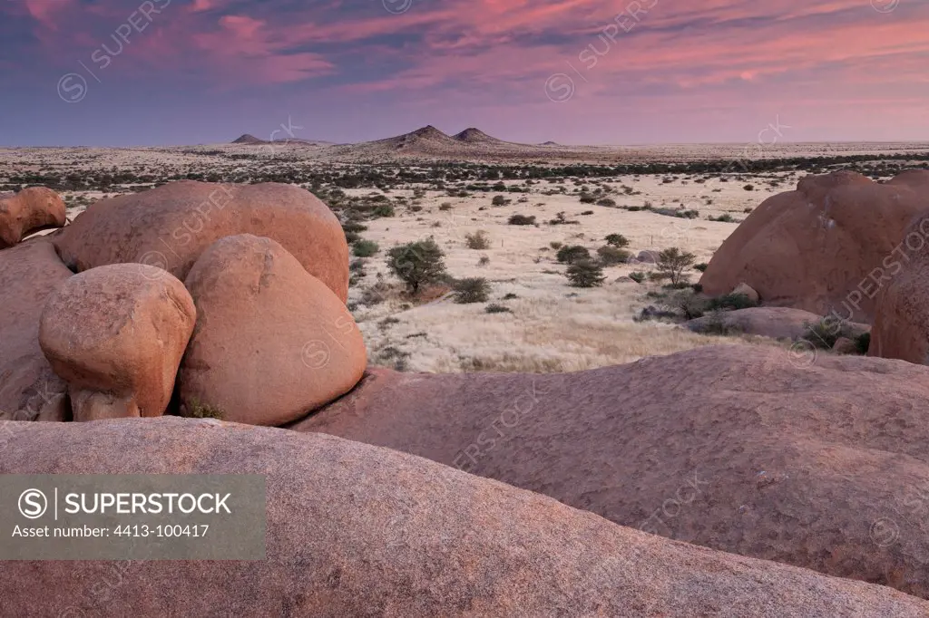 Granite boulders and far inselberg under the soft light