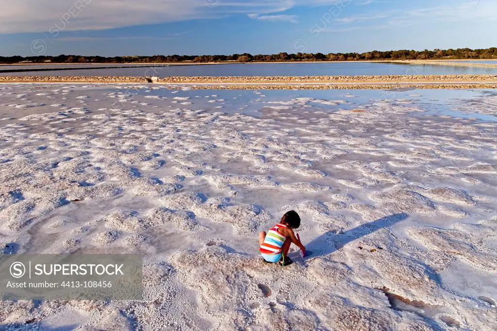 Children who harvests salt in saltworks of Ibiza