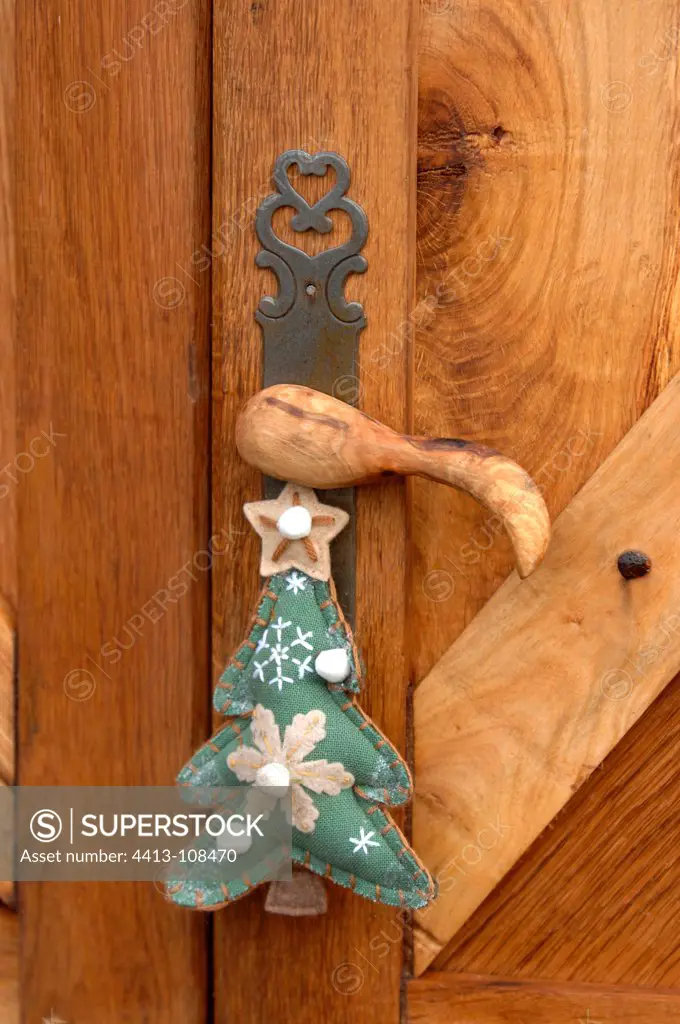 Christmas tree cloth hanging from the handle of a door