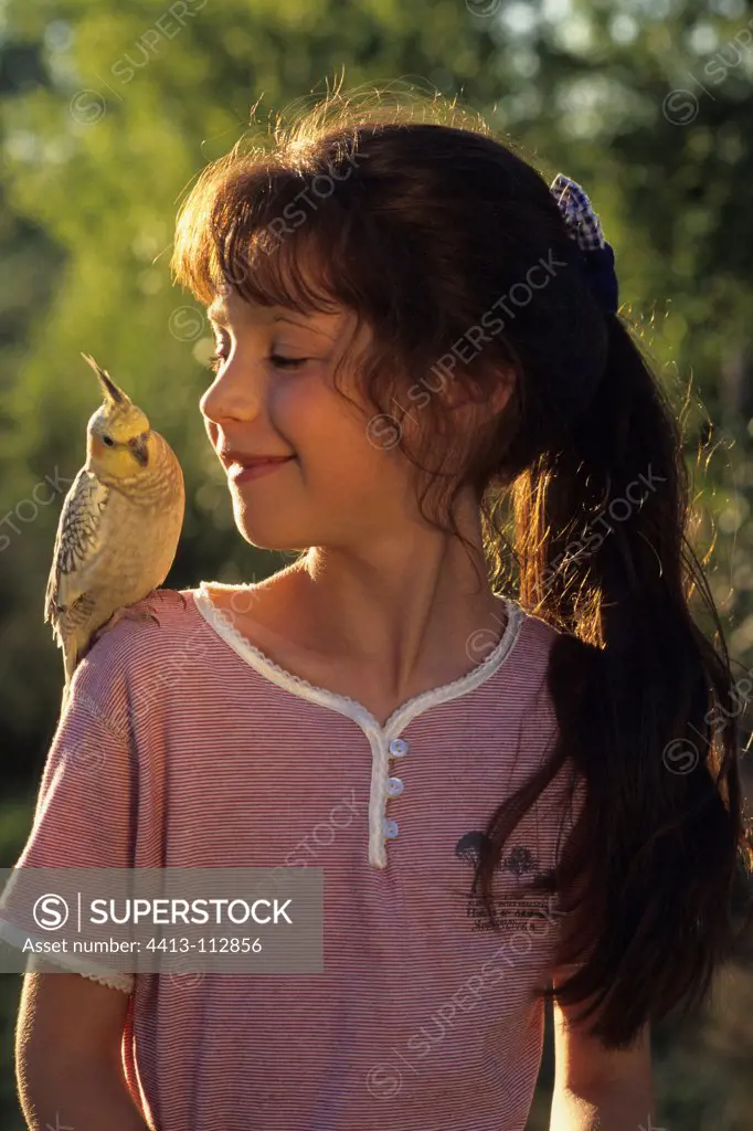 Girl with Cockatiel elegant on the shoulder