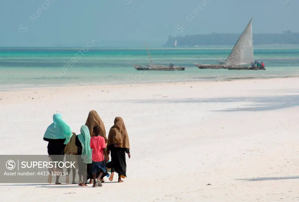 Women and children walking on the beach Zanzibar Unguja Island