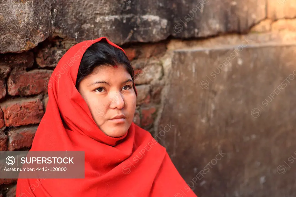 Woman wearing a veil simple red Kathmandu Nepal