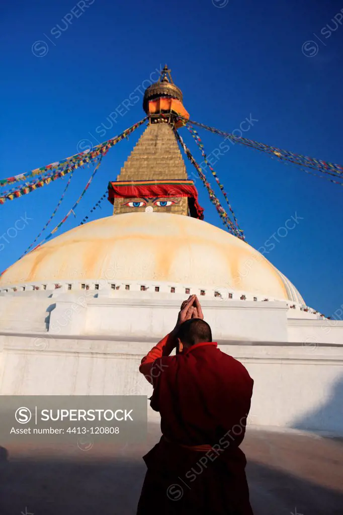 Monk praying before the stupa of Bodnath Kathmandu Nepal